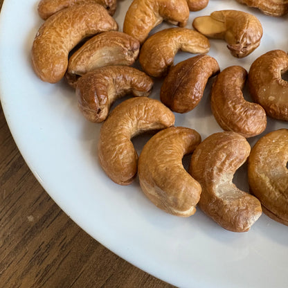 Plate of healthy handcrafted cashews in various shapes and sizes, perfect for snacking