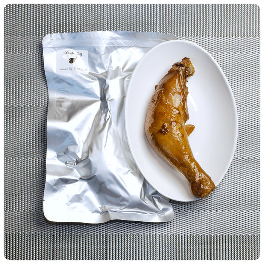 Whole chicken leg à la carte served on a plate beside its packaging from OKA-OKA 鸡肉专研所